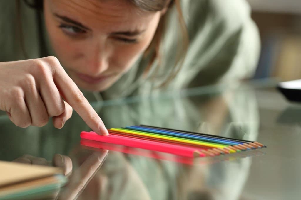 OCD Therapy Person carefully arranging coloured pencils