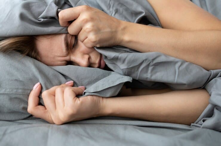 Sleep Disorders Person lying awake in bed with difficulty sleeping